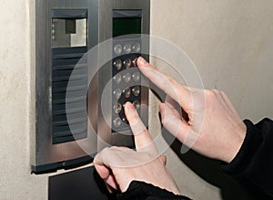 Hands Pressing on Intercom