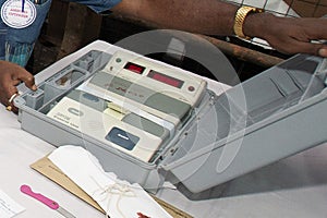 secured electronic voting machine (EVM) inside container during election process.