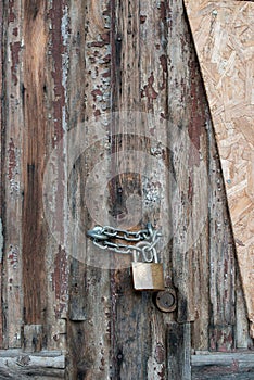 Secured Past: Padlock on Aged Wooden Door