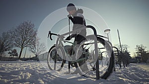 Security and antitheft lock for a bicycle. Man cyclist unlocks cycle in an outdoor bike parking lot in a European city