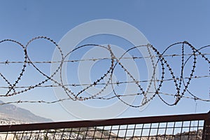 Security with a barbed wire fence. Protection concept design.