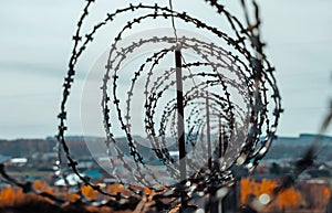 Security with a barbed wire spiral wound on the fence.