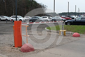Security barrier of a parking lot. Closed passage.