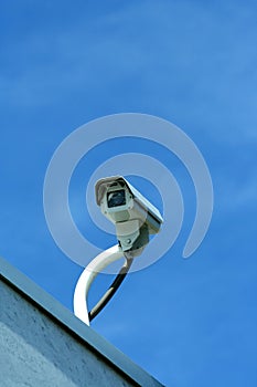 Security camera against blue sky