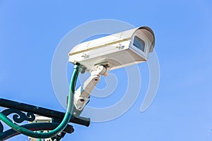 The security camera against blue sky