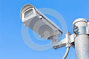 The security camera against blue sky