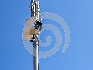 The security camera against blue sky