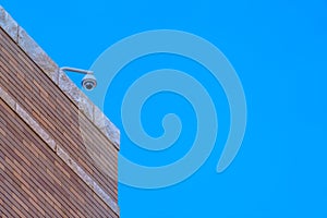 Security camera on a building against blue sky