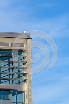 Security camera on a building against cloudy sky