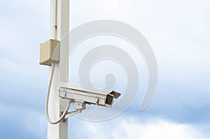 Security Camera on cloudy sky