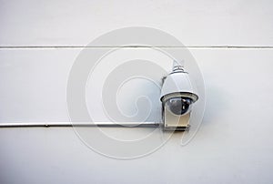 Security camera on concrete wall