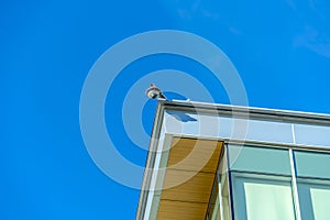 Security camera at the corner of a building roof