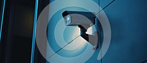 A Security Camera Mounted on a Blue Wall