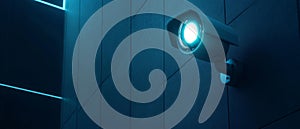 Security Camera Mounted on a Blue Wall with a Glowing Light