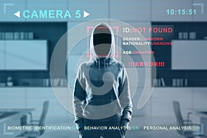 Security camera not recognizing hacker in hoodie standing in blurry office interior. ID, scanning, data theft and cctv concept.