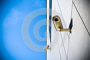 Security camera over blue sky