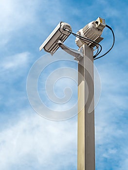 Security camera over blue sky
