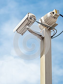 Security camera over blue sky