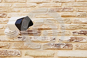 Security camera over brick wall