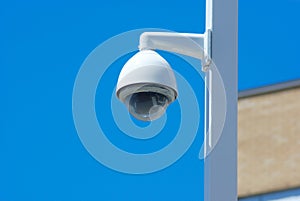 Security camera post outside on blue sky