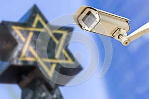 Security camera with star of David on background. concept of monitoring religious buildings of the Jewish faith