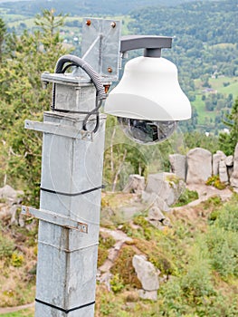 The security camera on street pole with tree foliage