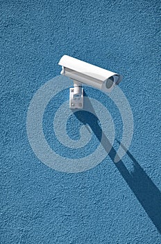 Security camera. Surveliance camera on a blue wall