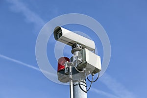 Security camera under blue sky