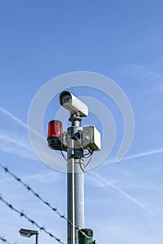 Security camera under blue sky