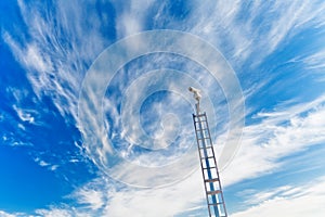 Security camera under blue sky