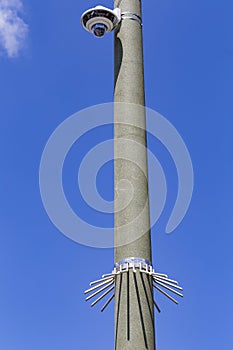 Security camera and urban video in front of blue sky. Outdoor cctv video surveillance cameras. Safety system area control outdoor