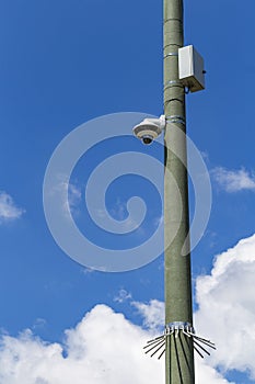 Security camera and urban video in front of blue sky. Outdoor cctv video surveillance cameras. Safety system area control outdoor