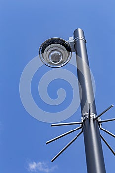 Security camera and urban video in front of blue sky. Outdoor cctv video surveillance cameras. Safety system area control outdoor