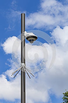 Security camera and urban video in front of blue sky. Outdoor cctv video surveillance cameras. Safety system area control outdoor