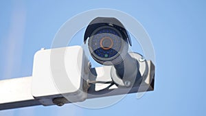 Security camera and urban video surveillance protection against theft of thieves against the blue sky outdoors
