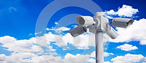 Security Cameras CCTV on pole on blue sky background. 3d illustration