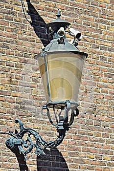 Security cameras installed in the design of the lamp on the building wall, surveillance, security