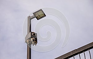 Security cameras and lights isolated against the sky