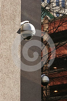 Security cameras look down on city street.