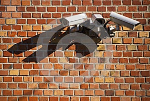 Security cameras on red brick wall