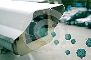 Security CCTV camera at car park entrance of supermarket with virus or germ to be scanned before entering