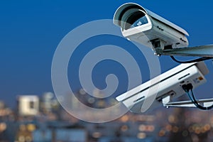 security CCTV camera monitoring system with panoramic view of a city on blurry background