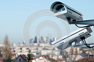 security CCTV camera monitoring system with panoramic view of a city on blurry background