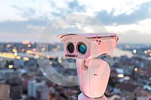 Security CCTV camera, surveillance system at blurred city background. Concept of city security and protection from