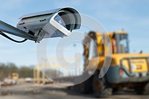Security CCTV camera or surveillance system with industrial site on blurry background