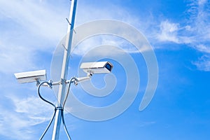 Security cctv cameras on pole blue sky background.