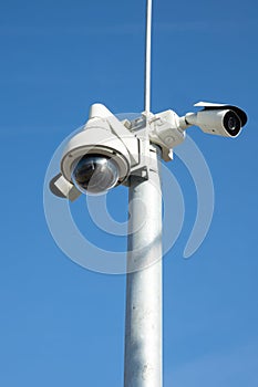 Security cctv cameras on pylon. Surveillance cameras for privacy and protection on blue background