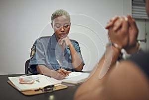 Security, criminal and female police officer at the station writing a legal report for social justice. Law enforcement