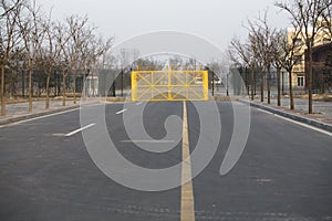 Security gate by yellow fence