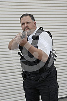 Security Guard In Bulletproof Vest Holding Gun photo